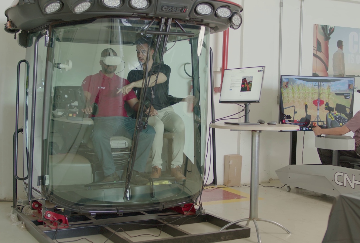 A CNH employee in a cab operation simulator undergoing interactive training via a virtual reality headset