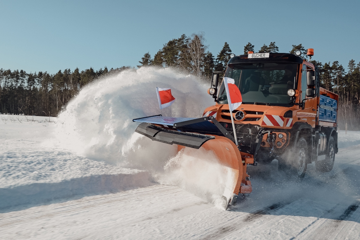 Unimog implement carrier with winter service equipment by Bucher Municipal