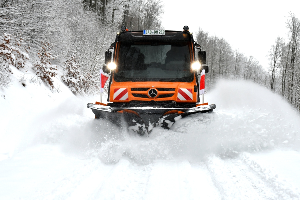 Unimog implement carrier with winter service equipment by Bucher Municipal