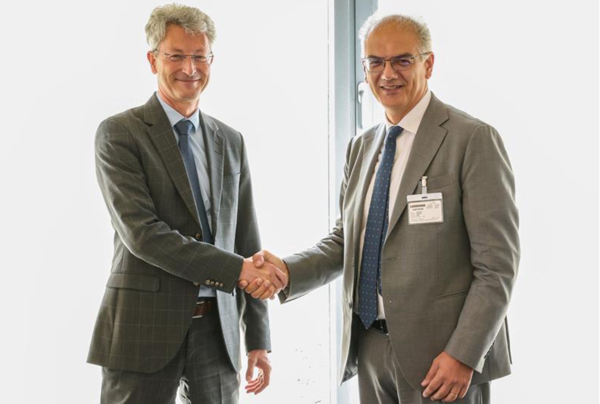 Mr Weiss of Liebherr Mining and Mr Renato Bruno of Bruno Generators Group sign the agreement.