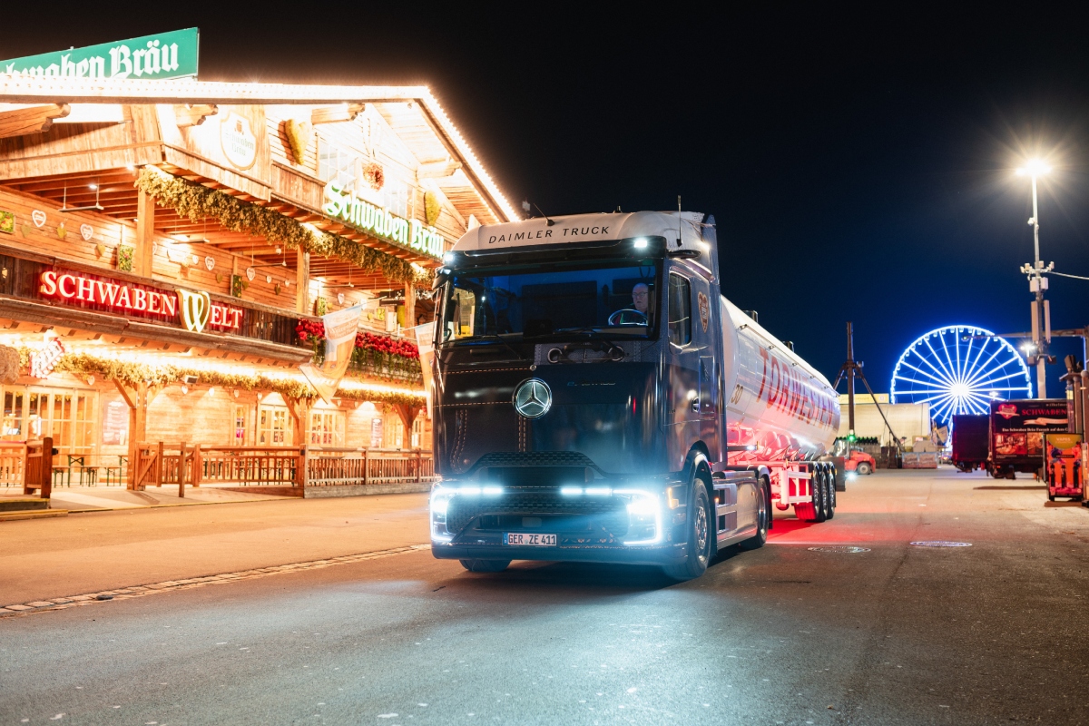 The Mercedes-Benz eActros 600, adorned in a distinctive dirndl and lederhosen-themed wrap, delivers supplies to the Schwabenbräu festival tent at the Cannstatter Volksfest.