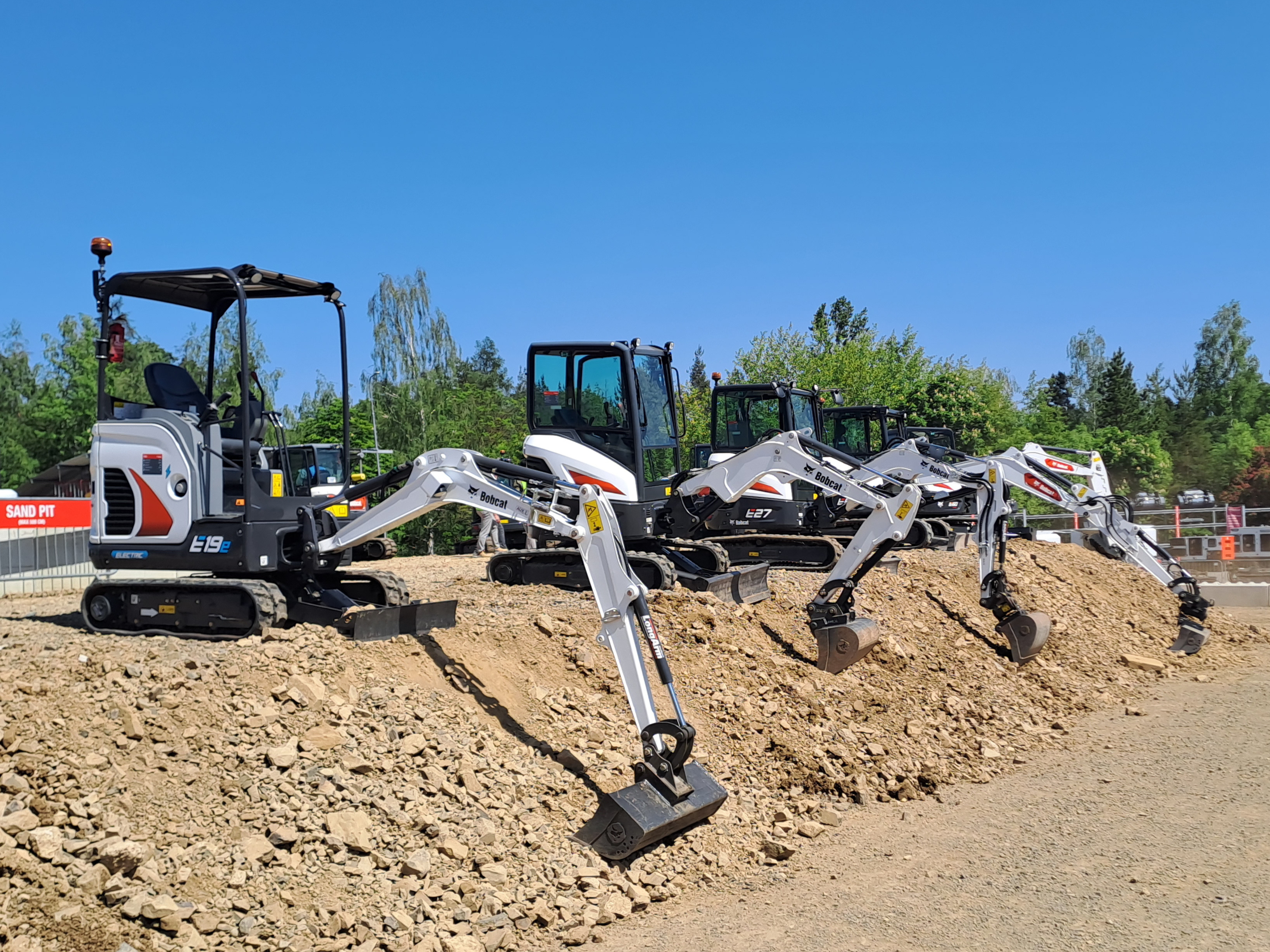 A lineup of Bobcat mini excavators, led by the E19e electric model