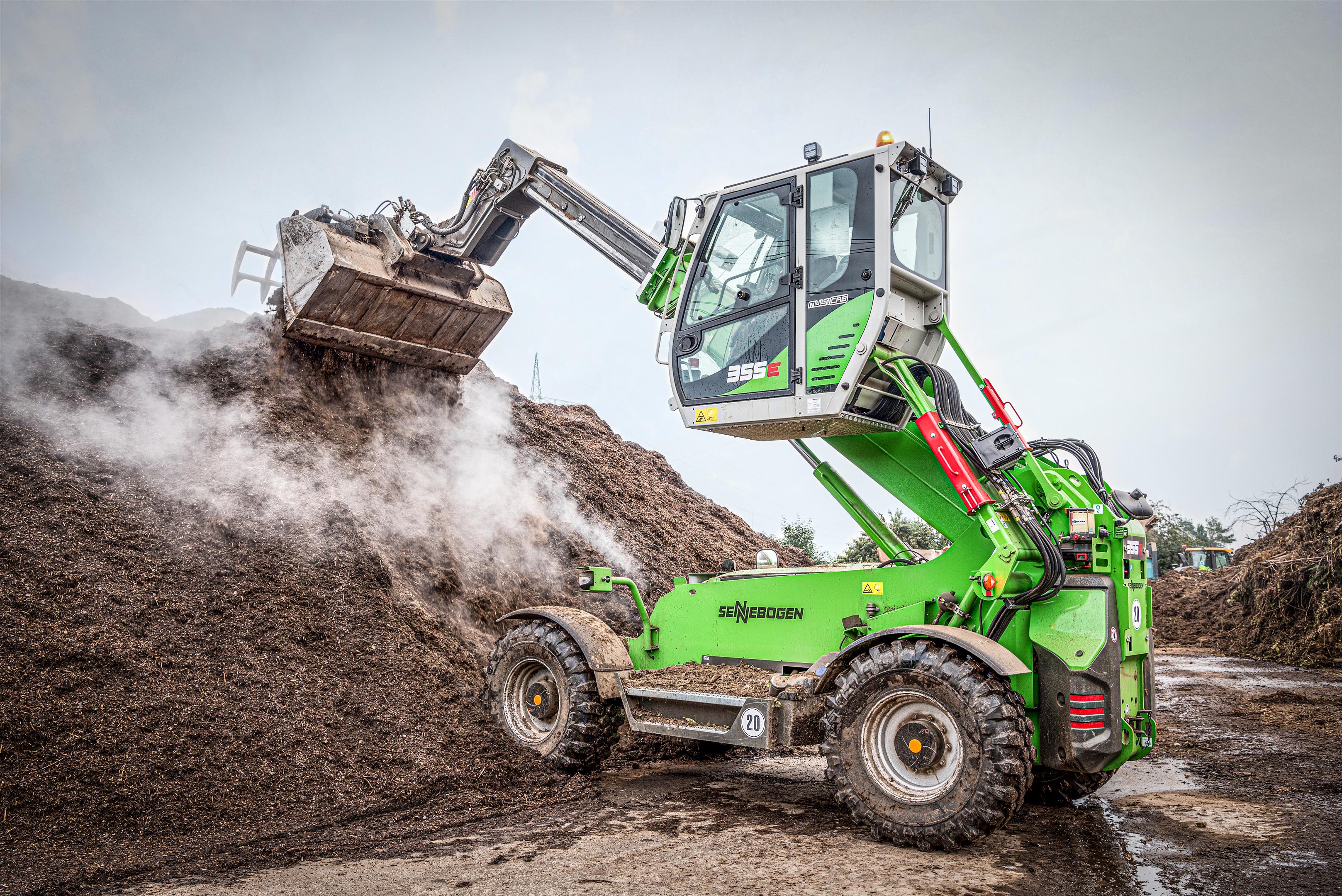 The SENNEBOGEN 355 E telehandler makes it easy to stack up high layers of bark mulch.