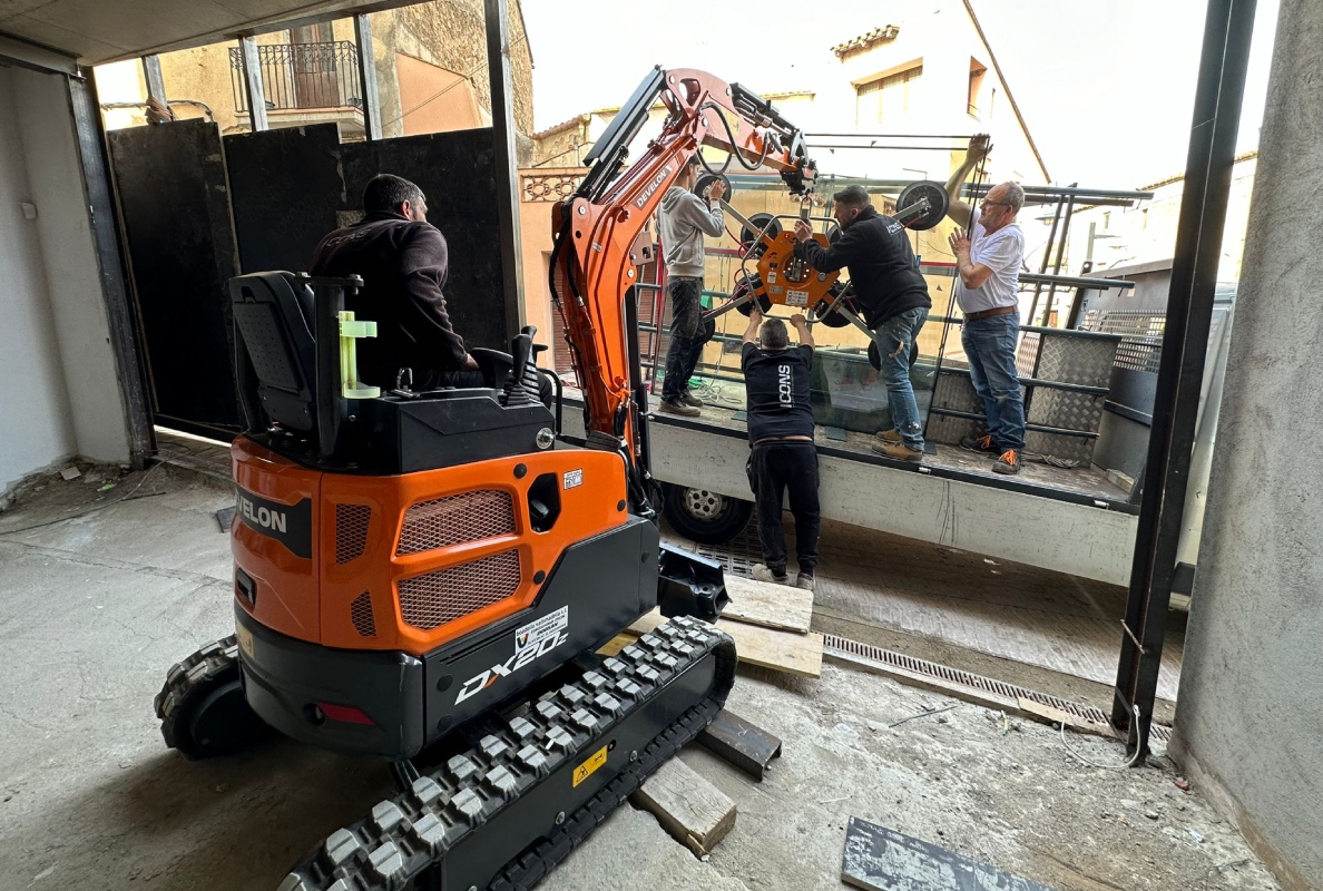 Develon Mini-Excavator Used to Install Panes of Glass in Home