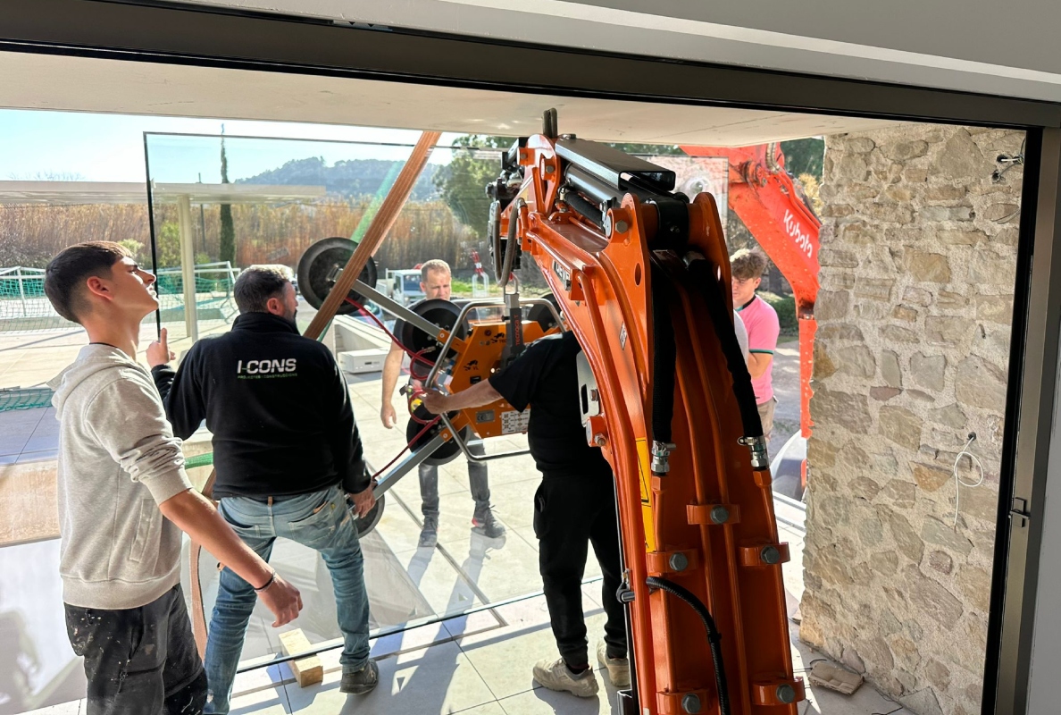 Develon Mini-Excavator Used to Install Panes of Glass in Home