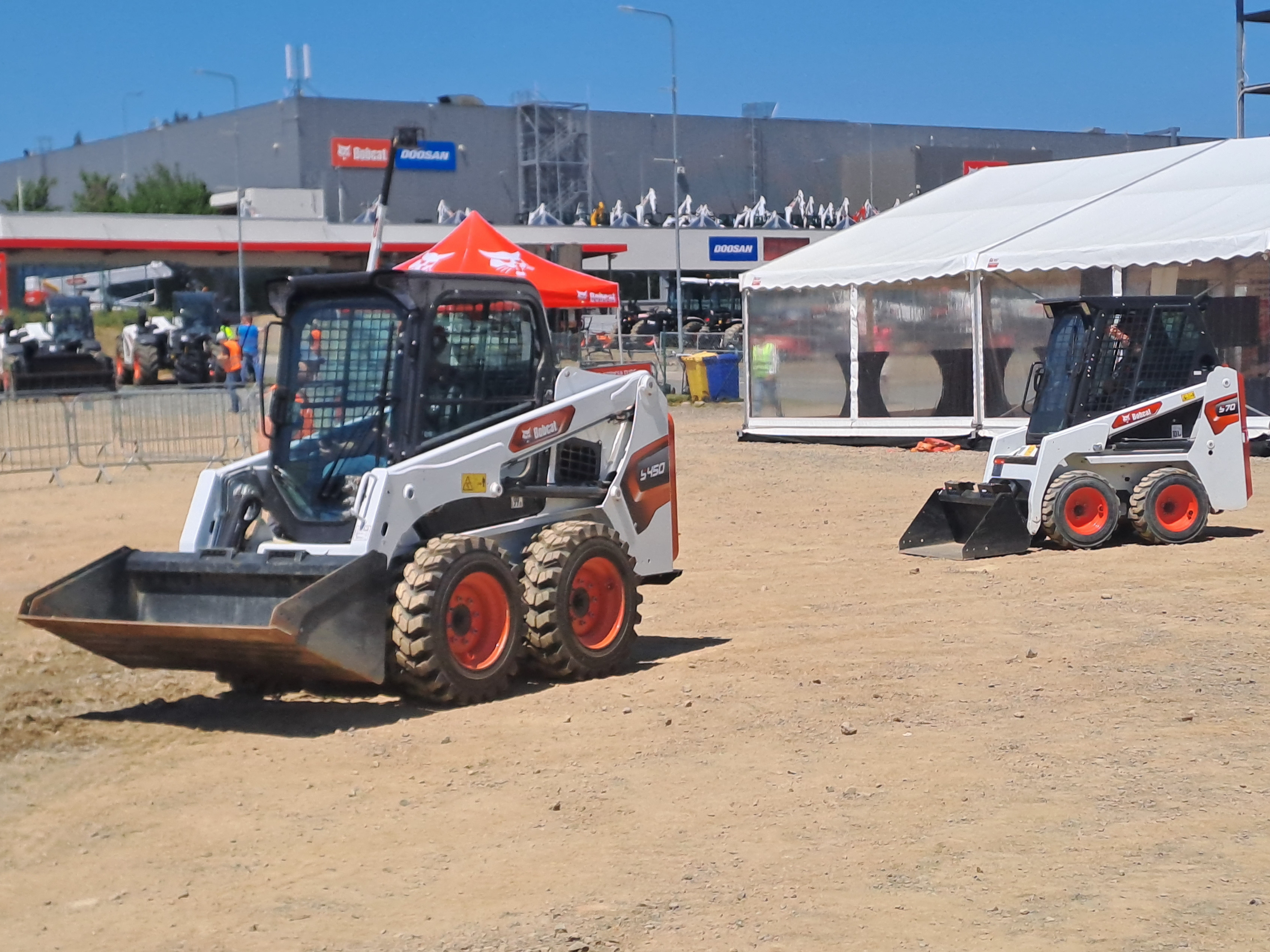 Bobcat S450 and S70 skid-steer loaders demonstrating their agility on the demo field
