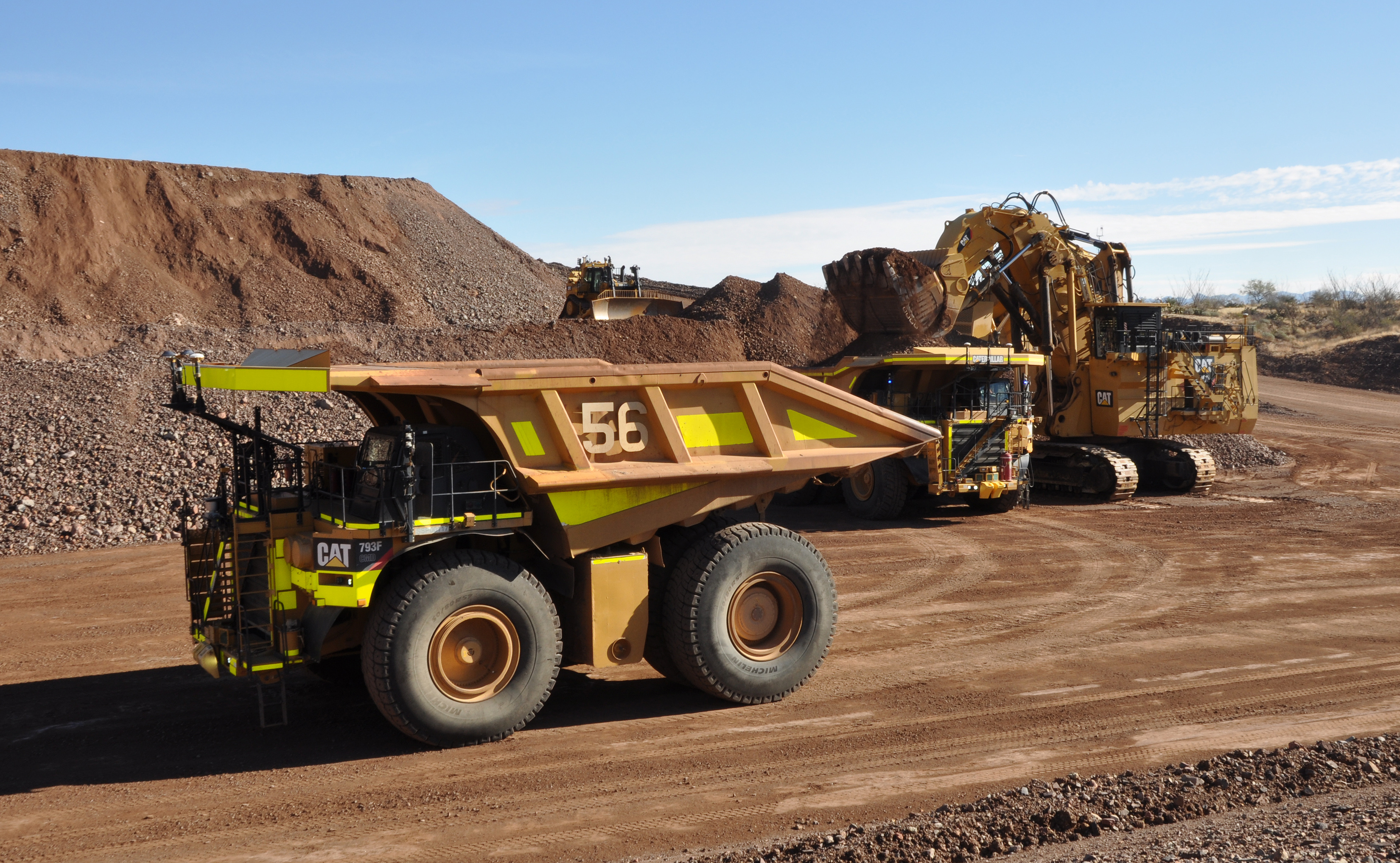 Cat autonomous truck stages for loading as ... ading another 793F CMD in demonstration