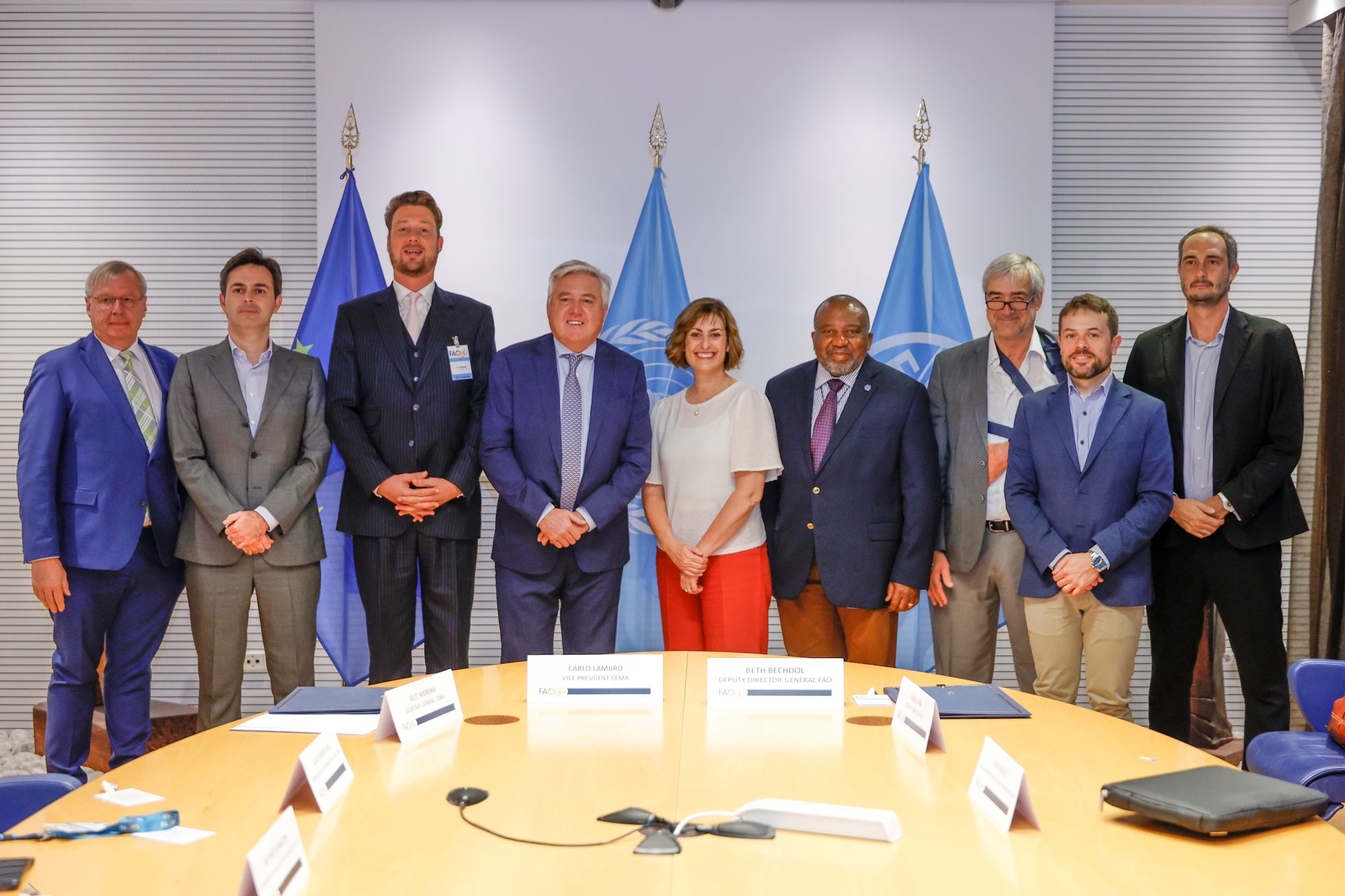 Beth Bechdol, FAO Deputy Director-General, and Carlo Lambro, CEMA Vice President stand for a group photo at the end of the FAO/CEMA Signing ceremony at the FAO headquarters.