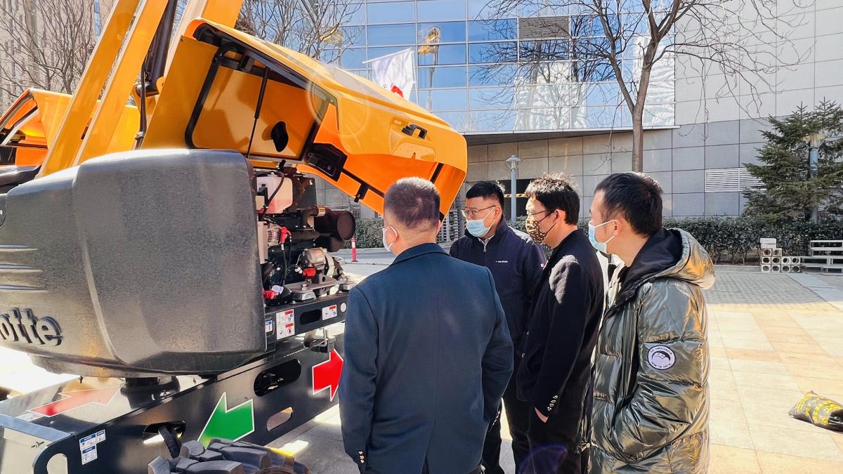 Visitors getting hands on experience and technical explanations with Haulotte lifting equipment