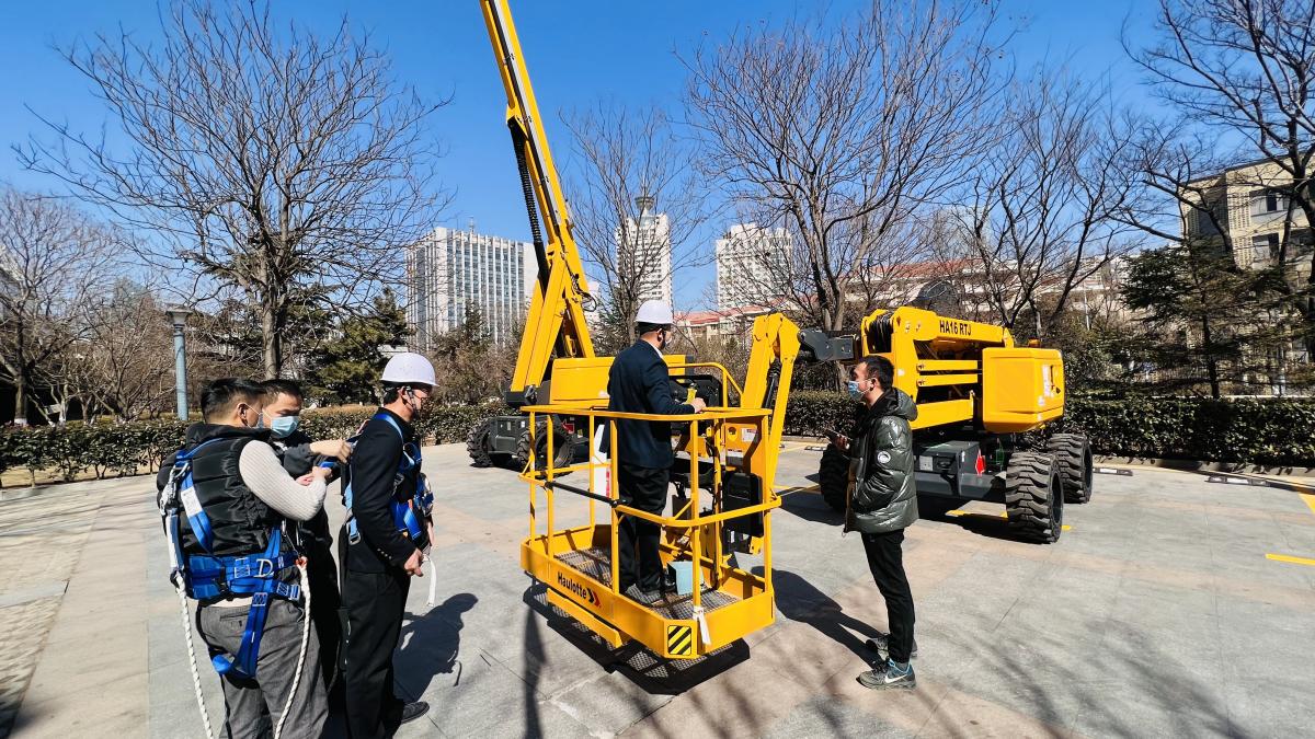 Visitors getting hands on experience and technical explanations with Haulotte lifting equipment