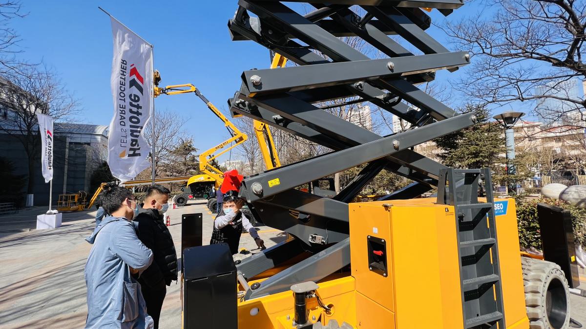 Visitors getting hands on experience and technical explanations with Haulotte lifting equipment