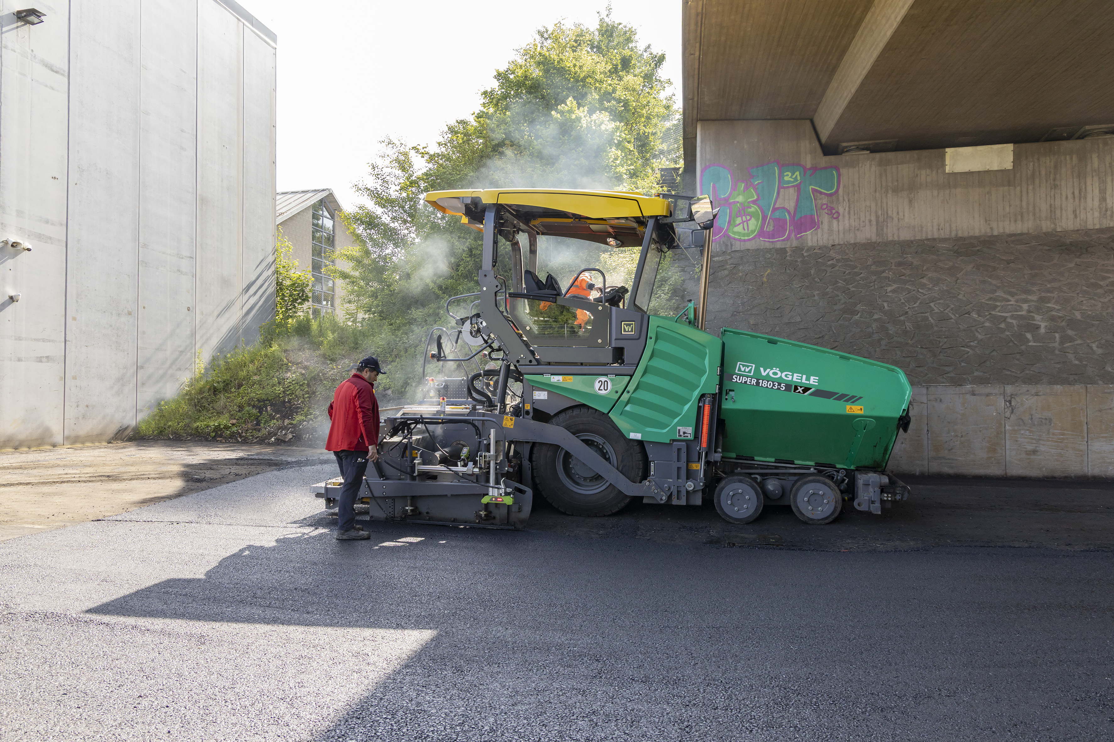 Wheeled paver resurfaces yard with winding roadways