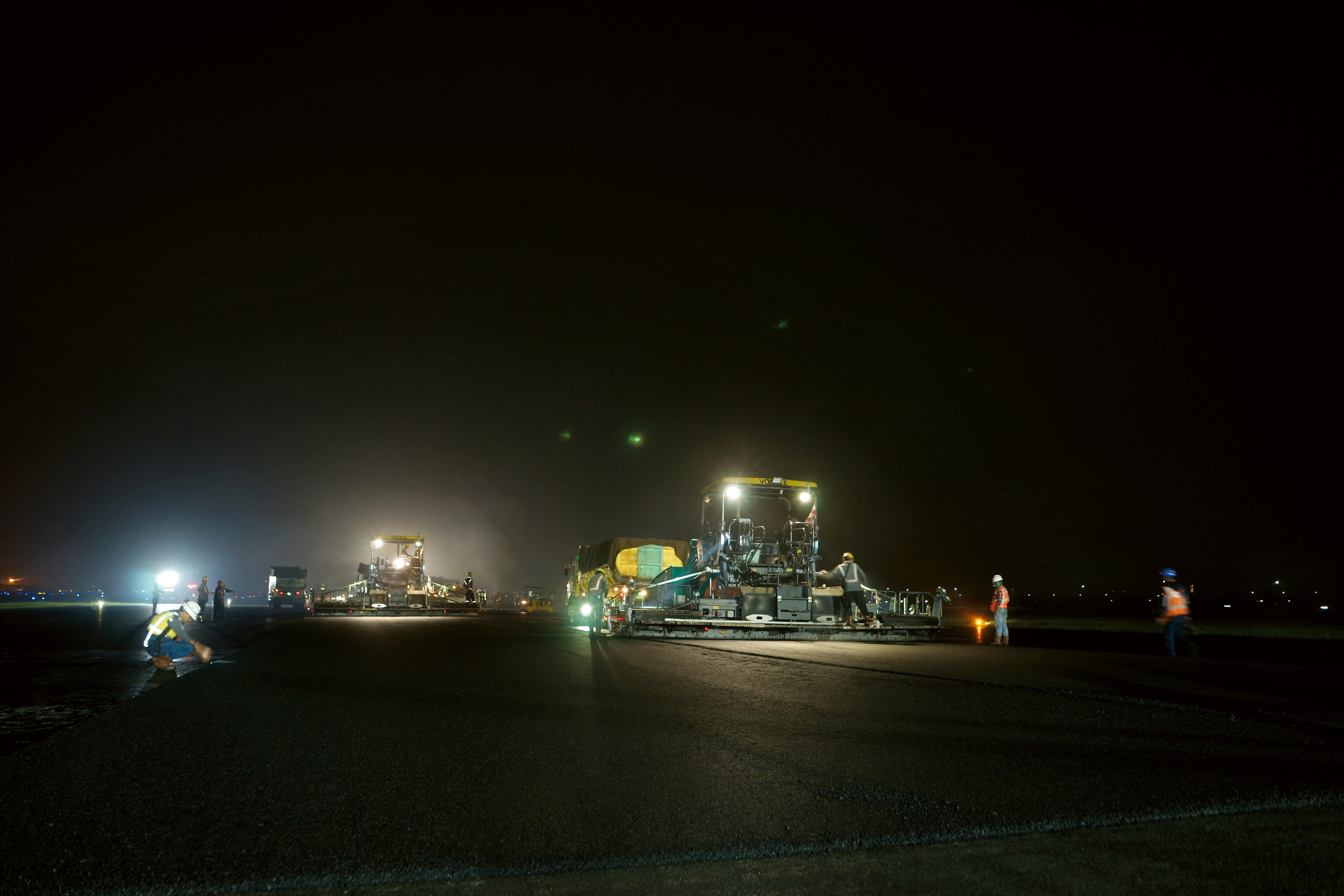 Two pavers work through the night at Indonesia’s largest airport