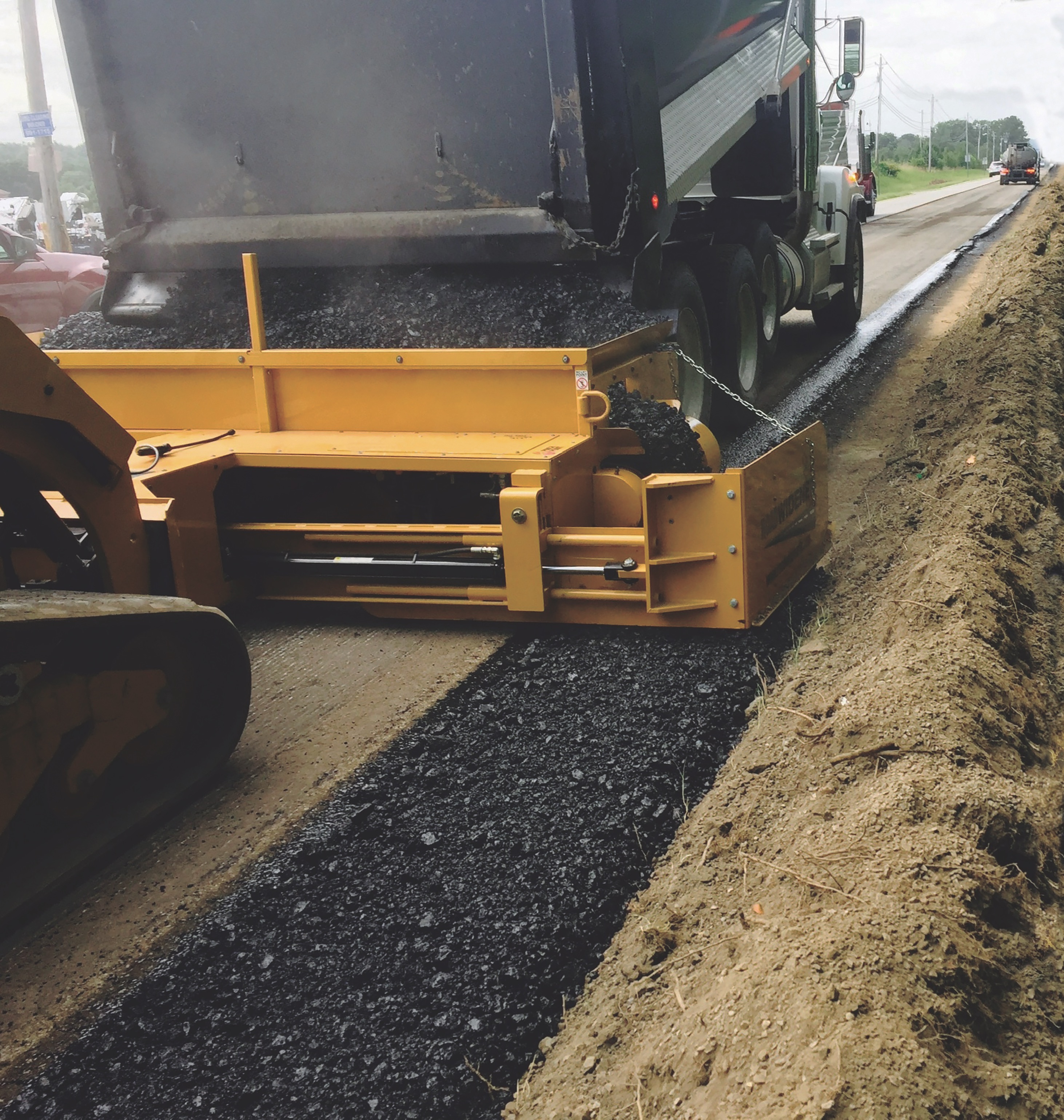 Road Widener’s FH-R Material Placement  Attachment Reduces Labor by 50%