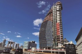 Convex Mixed‐Use Building Rises Next to The Brooklyn Bridge