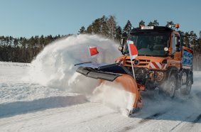 Unimog implement carrier with winter service equipment by Bucher Municipal