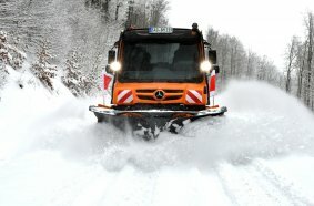 Unimog implement carrier with winter service equipment by Bucher Municipal