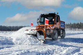 Unimog implement carrier with winter service equipment by Bucher Municipal