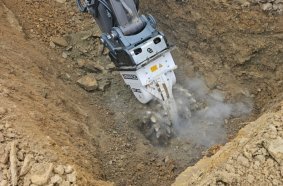 The rotary drum cutter attachment in action. Mounted on the large excavator, this attachment cut a large proportion of the solid dolomite rock.