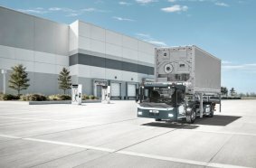 Visualization of the KAMAG ePM 101 with newly designed cab in operation on a logistics yard.