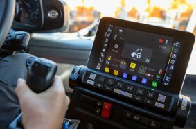 The driver controls the Unimog's attachments for winter service using the UNI-TOUCH operating system with joystick and display