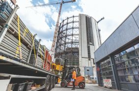 A new, circular building with 15 floors was constructed inside the steel structure.