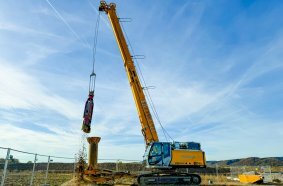 The grab is then attached to excavate the soil material.