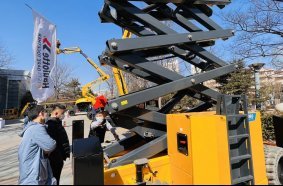 Visitors getting hands on experience and technical explanations with Haulotte lifting equipment