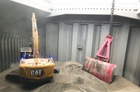 Cat® Command Stations in an office environment being used to remotely control excavators.
