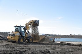 The Cat 908 compact wheel loader in a high lift configuration