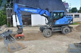 The Hyundai HW180 wheeled excavator at work replacing a 2,500-metre-long main  sewerage line in Minderoffingen. Compacting a freshly filled trench with a vibrator  attachment.