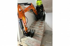 Develon Mini-Excavator Used to Install Panes of Glass in Home