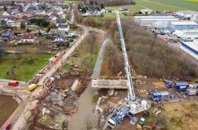 THW Bielefeld hoists a 46 tonne temporary bridge with the help of the LTM 1650-8.1 over the River Erft in the Euskirchen 
disaster zone. It will be a massive help to the people there and represents a major step forward in the reconstruction efforts.