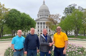 Nicholas Reynolds, Nathanael Reynolds, and Mark Reynolds, of Reynolds Rigging & Crane Service, and Aaron Ravenscroft, Manitowoc’s president and CEO.