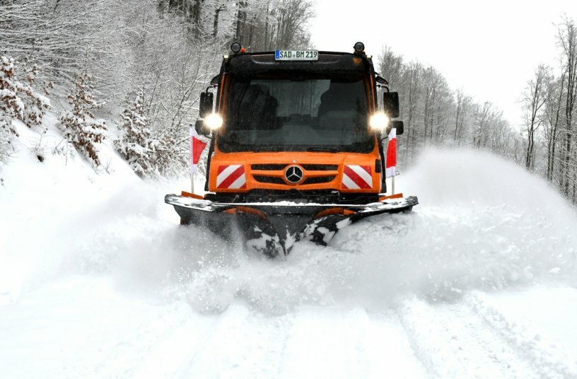 Unimog implement carrier with winter service equipment by Bucher Municipal<br>IMAGE SOURCE: Daimler Truck AG