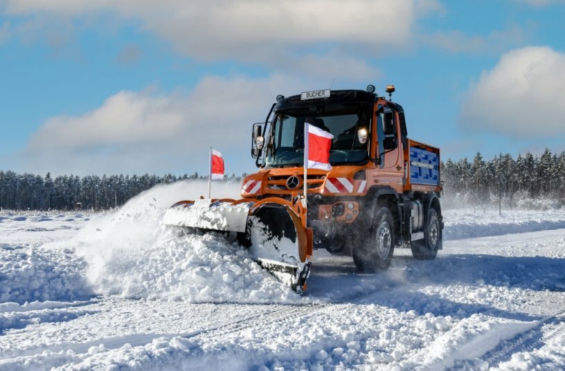 Unimog implement carrier with winter service equipment by Bucher Municipal<br>IMAGE SOURCE: Daimler Truck AG