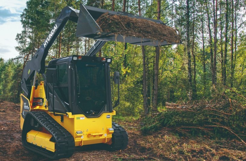 The Hyundai HT100V compact track loader has a rated operating capacity of 2,300 pounds (1,220 kg), and its heaped bucket capacity is 0.58 yd3 (0.44 m3).<br>IMAGE SOURCE: Cooper Hong Inc.; Hyundai Construction Equipment Americas, Inc.