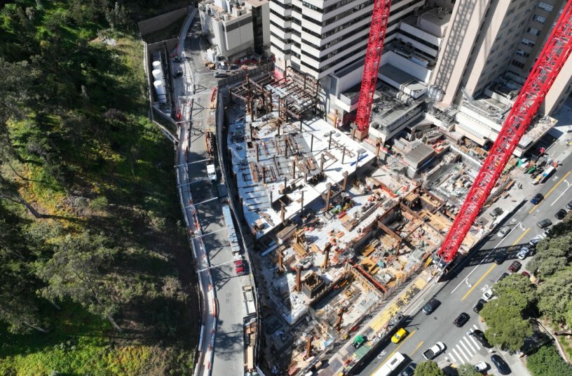 The confined construction site offers very little room for material handling, logistics, or construction vehicles. Throughout the entire project, the two WOLFF 1250 B cranes serve as the site’s primary transportation system.<br>IMAGE SOURCE: © Herrero Boldt Webcor