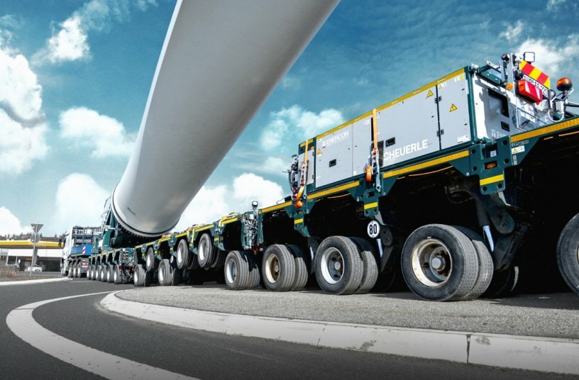 The transport combination of tractor unit and SCHEUERLE transport equipment – consisting of 16 axle lines of fully modular platform trailers and a BladeLifter – reaches overall lengths of more than 100 metres in towed configuration.<br>IMAGE SOURCE: TII Group