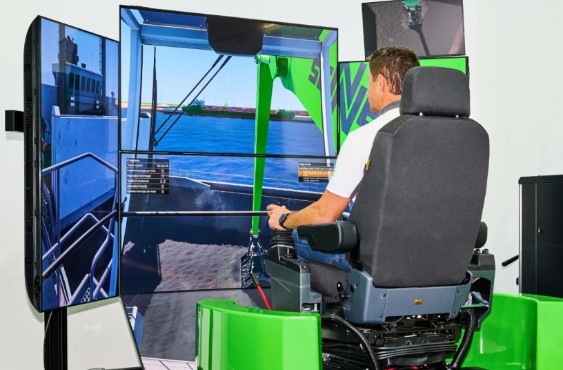 At the SENNEBOGEN Log Handling Simulator, a visitor controls a virtual log handling operation across several screens.<br>IMAGE SOURCE: SENNEBOGEN Maschinenfabrik GmbH