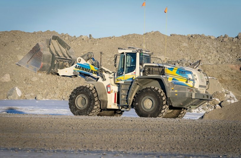An XPower L 586 wheel loader in the design of the Swedish national flag is in use in northern Sweden.<br>IMAGE SOURCE: Liebherr-Werk Bischofshofen GmbH