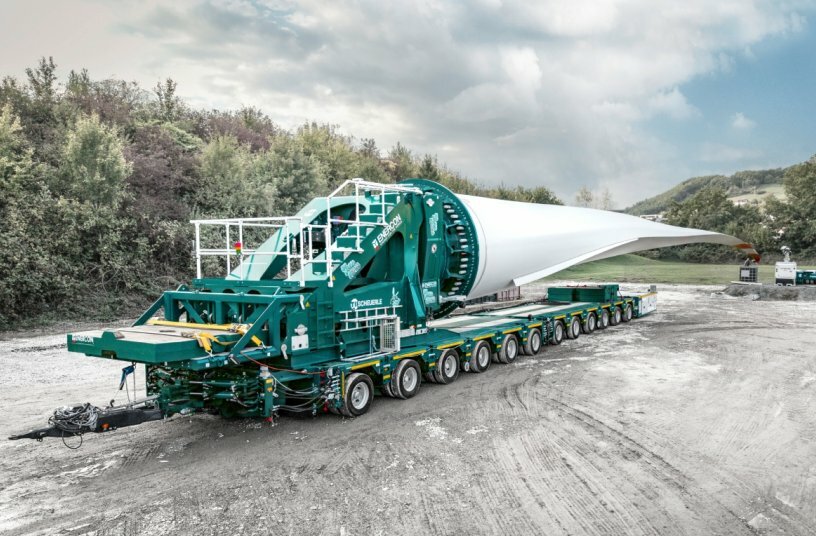 The SCHEUERLE BladeLifter G4 in action for ENERCON: Transporting the approximately 68-meter-long rotor blades required navigating narrow farm roads and challenging terrain.<br>IMAGE SOURCE: TII Group