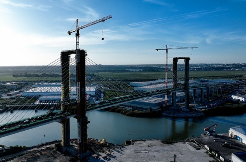 The two 420 EC-H Litronic cranes show what they are capable of, lifting 7.5 tonne metal reinforcements at a height of 110 metres.<br>IMAGE SOURCE: Liebherr-Werk Biberach GmbH