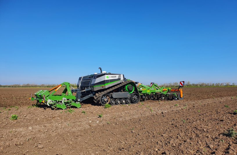 The tracked AgXeed AgBot with 3 m AMAZONE Cenio mounted cultivator and front-mounted knife roller<br>IMAGE SOURCE: AMAZONEN-WERKE H. DREYER SE & Co. KG