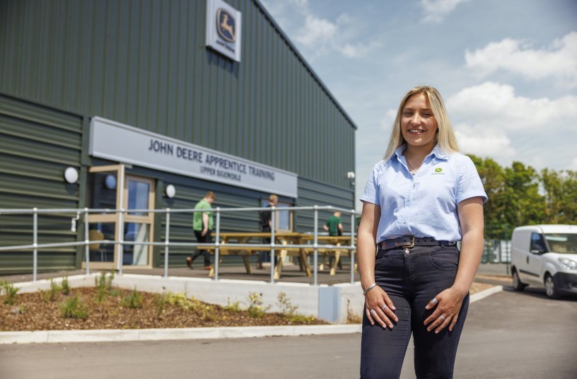 Honor Miles, an Apprentice Technician, stands in front of the new John Deere Training Centre.<br>IMAGE SOURCE: John Deere Limited