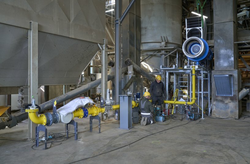 The burner and its supply periphery are assembled before the dryer drum is set up in its final location. <br>IMAGE SOURCE: WIRTGEN GROUP
