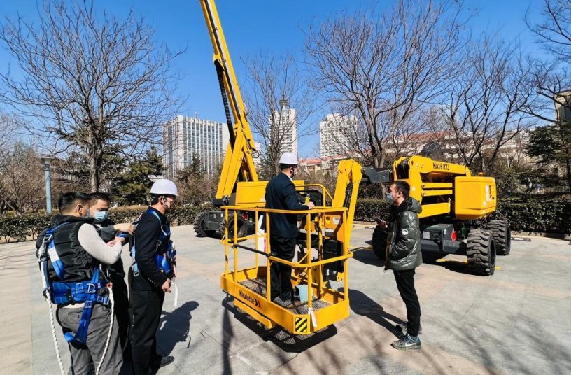 Visitors getting hands on experience and technical explanations with Haulotte lifting equipment<br>IMAGE SOURCE: Haulotte Group