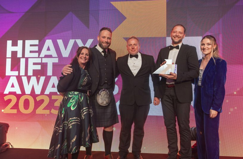 From left to right: Lyle Sibbald (Sales Manager Scottland), Paul Goodall (Sales Manager UK) and Michael Heckenberger (Liebherr-Werk Ehingen GmbH) accept the Heavy Lift Award for Liebherr. The English actress, author, presenter and comedian Lucy Porter (left) hosted the award ceremony.<br>IMAGE SOURCE: Liebherr-Werk Ehingen GmbH