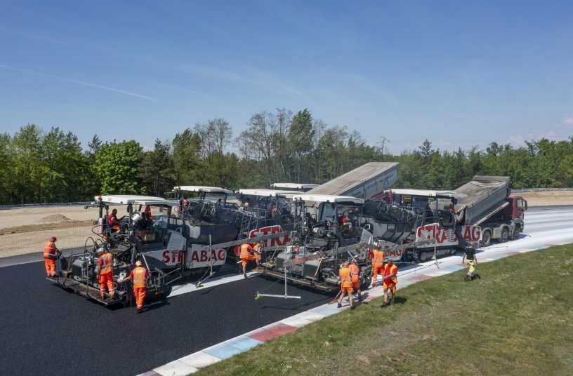 Exact timing and perfect interaction of tipper trucks with material feeders and pavers from Vögele were decisive factors in ensuring seamless, uninterrupted paving operations.<br>IMAGE SOURCE: WIRTGEN GROUP