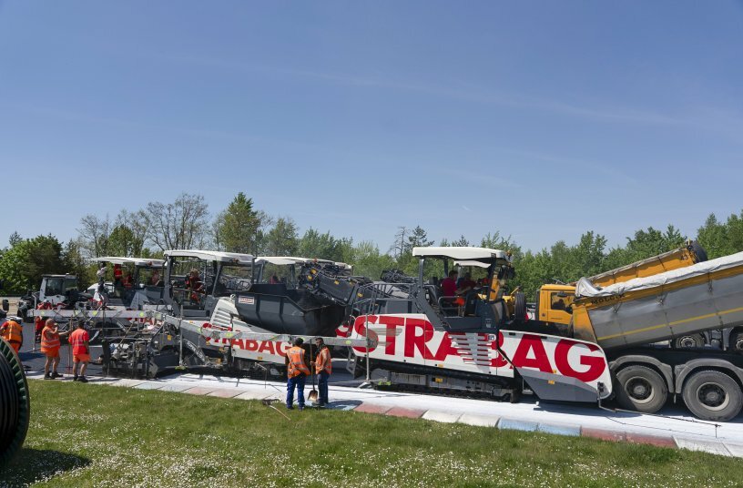 Tipper trucks with thermal insulation delivered the special asphalt mix directly to the material feeders for continuous transfer to the Vögele pavers. <br>IMAGE SOURCE: WIRTGEN GROUP